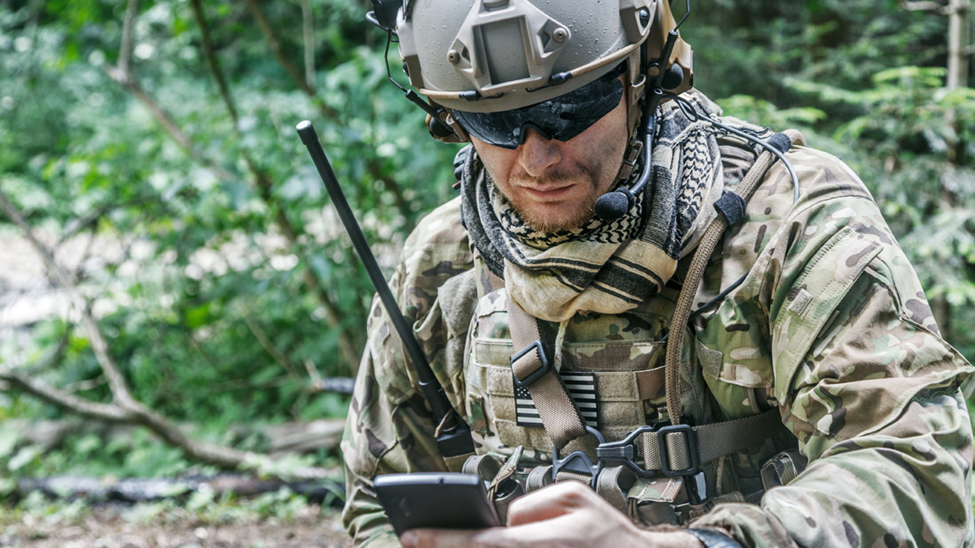 Soldier using a smartphone in the field
